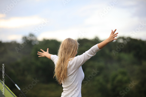 Happy and relaxation Young woman lift hand up Breathe fresh air in to lung, Happy and successful