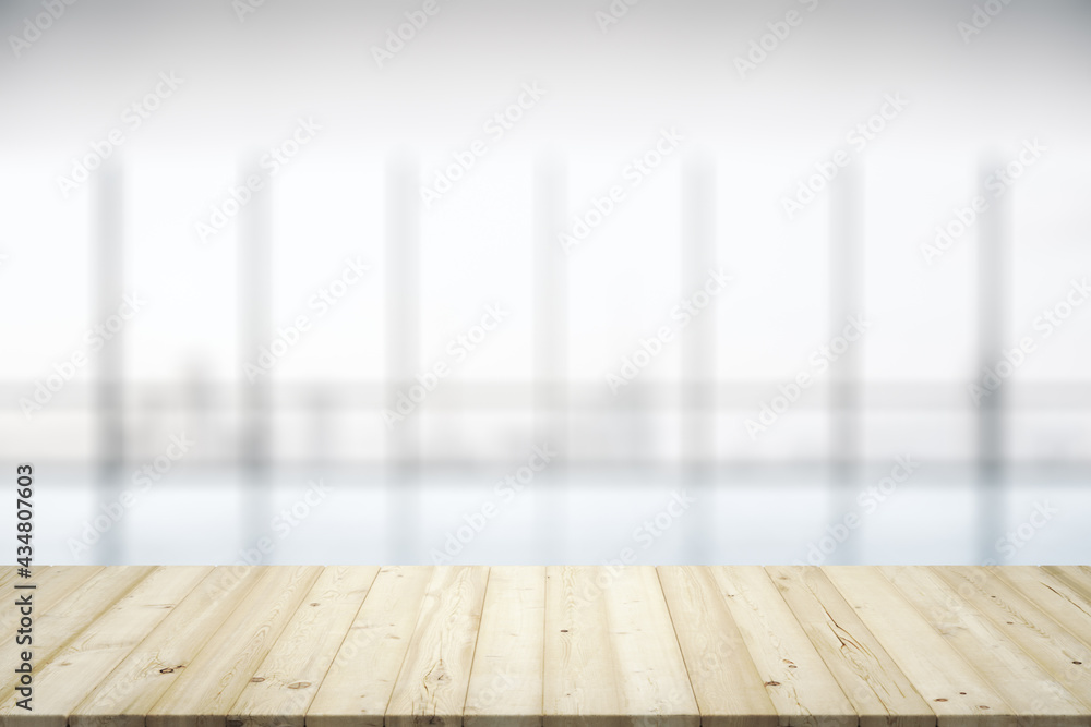 Blank wooden desktop with empty space on modern office interior with large window background, close up, mockup Blank wooden desktop with empty space on modern office interior with large window background, close up, mockup
