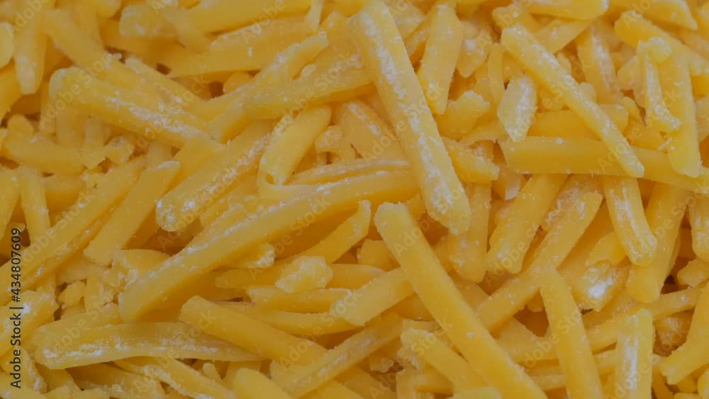 Overhead slider shot of grated cheddar cheese in a mound Overhead slider shot of grated cheddar cheese in a mound