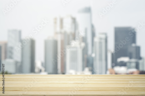 Blank tabletop made of wooden planks with beautiful blurry cityscape in the afternoon on background  mockup
