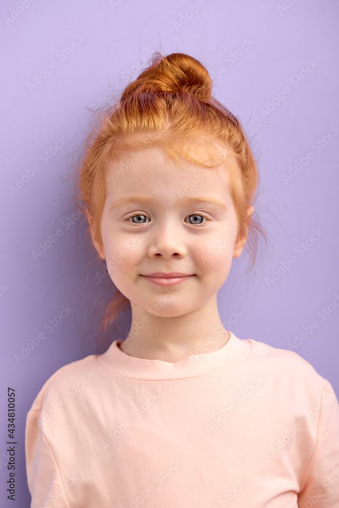 cute smiling caucasian child girl with red hair and big blue eyes isolated over purple background. natural red haired girl with freckles look at camera with pleasant face, glad and nice girl cute smiling caucasian child girl with red hair and big blue eyes isolated over purple background. natural red haired girl with freckles look at camera with pleasant face, glad and nice girl