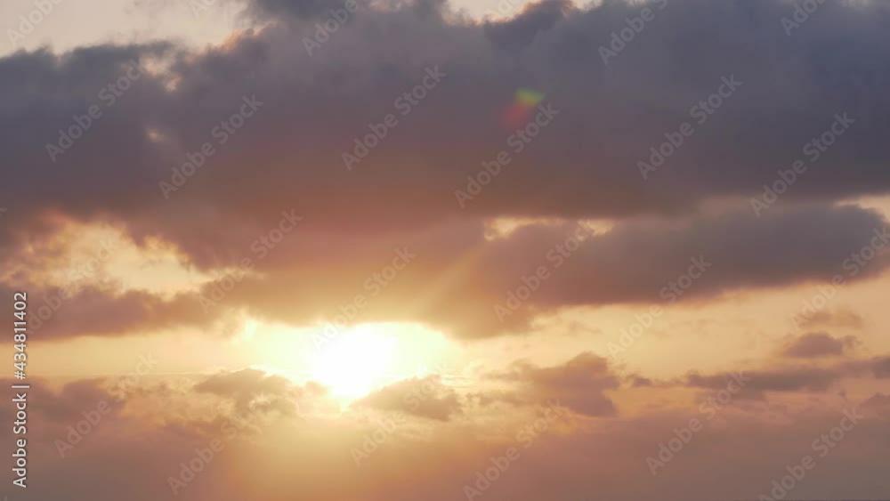Dramatic timelapse sunrise over storm clouds. Beautiful gold dawn scene