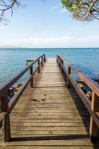 Deck on the beach with a beautifull landscape view of the ocean and nature. Blue sky