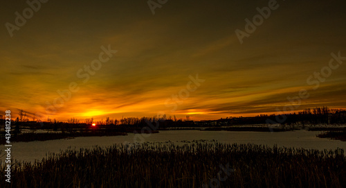 An image taken as the sun set below the horizon over a frozen pond near our home in Didsbury Alberta Canada.