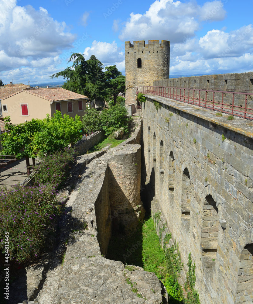 Part of the city wall of Carcassonne with tower on a sunny day.