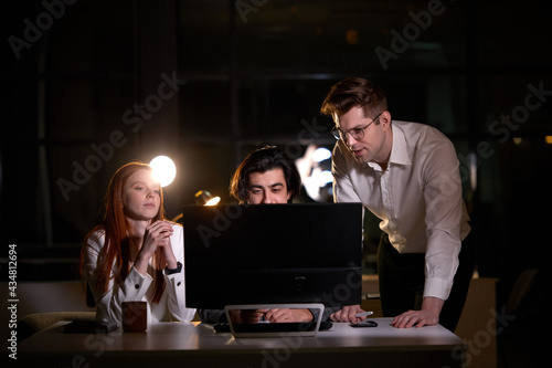 Group of young confident business colleagues in team discussing startup project at night. tired sleepy Caucasian Business People with pc computer working late,brainstorm concept. Copy space