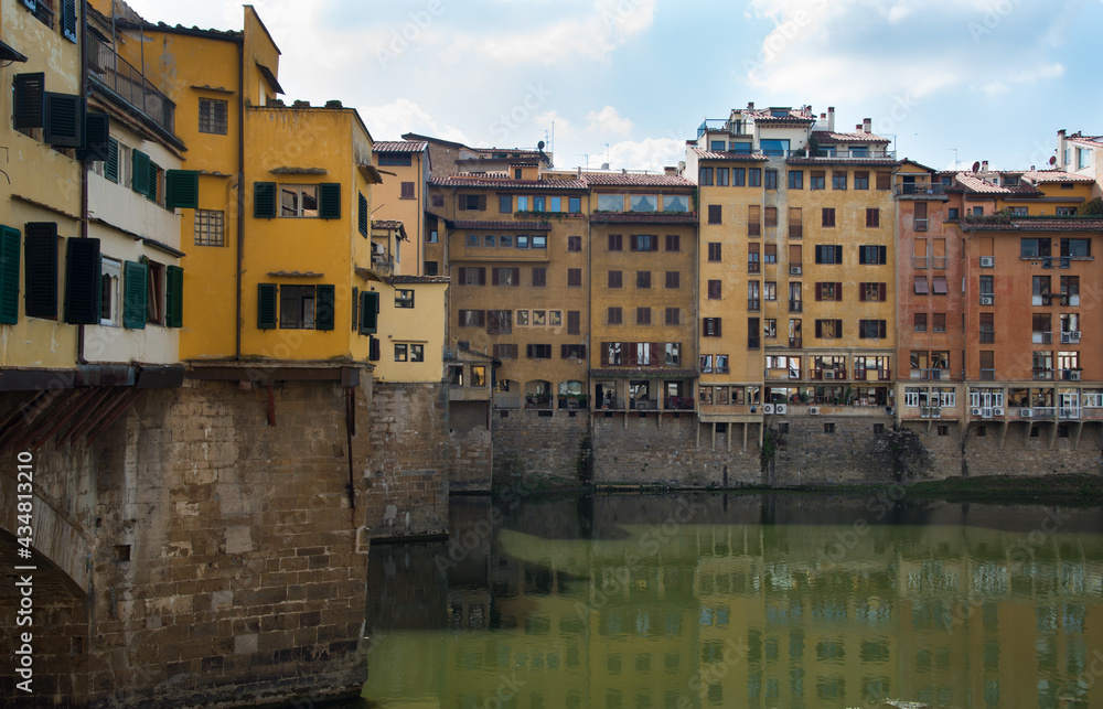 Ponte Vecchio landmark reflected on arno river. Florence, Tuscany Italy.