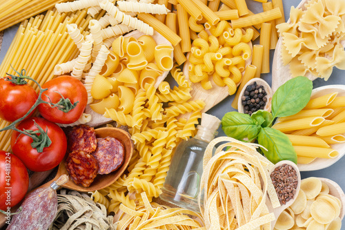 composition of raw pasta and spaghetti different shapes, frame of raw pasta. room for text	
 photo