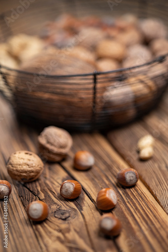 still life with hazelnut peanuts walnut and coconut on wooden board