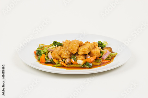 Chinese food with fried chicken and vegetables.