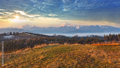Morning sunrise spring Carpathian mountains plateau landscape with snow-covered ridge tops in far, Ukraine. © wildman