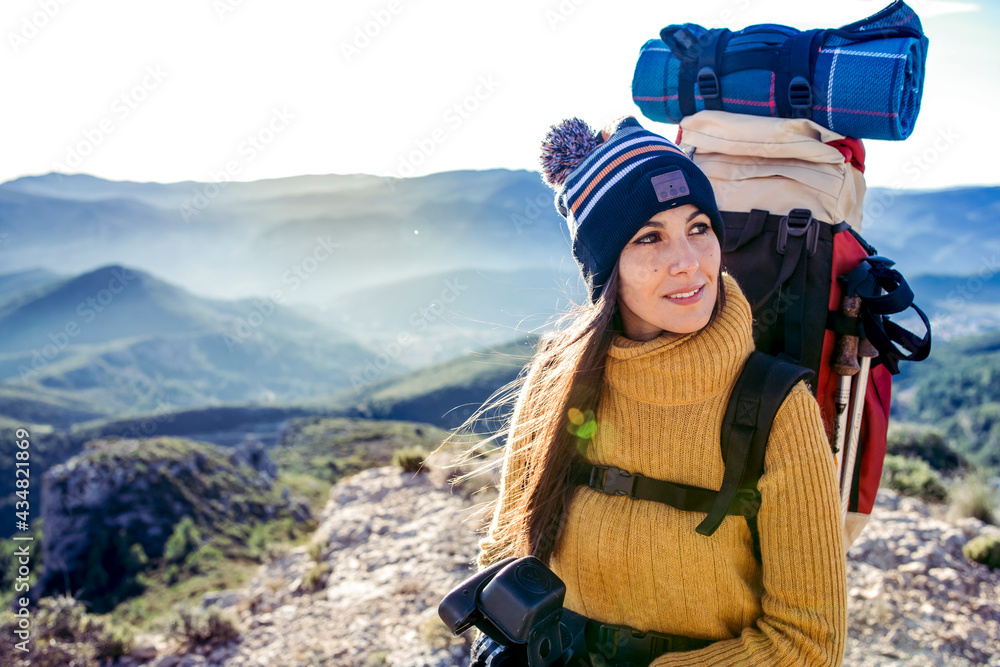 Beautiful girl looking at the mountain scenery. Travel and lifestyle concept.