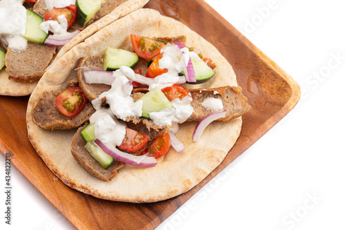A Gyro with Vegetables and Garlic White Sauce on a White Background