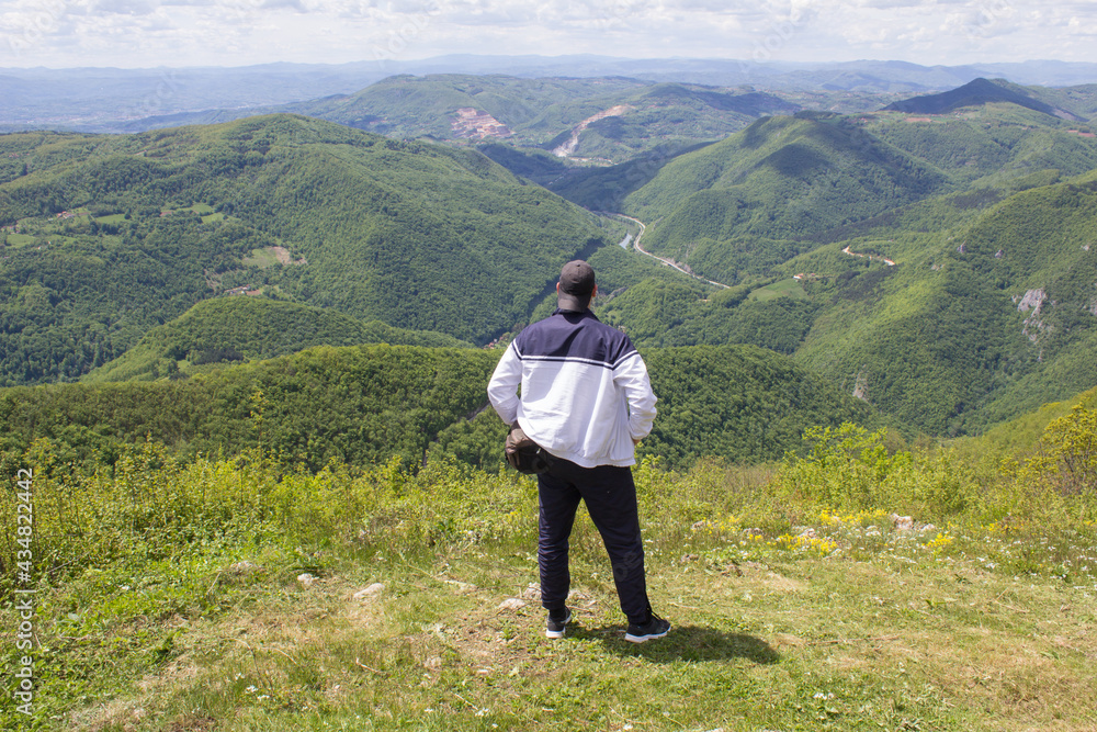 The tourist enjoys the beautiful view from the mountain Ovčar. Mount Ovčar is located in western Serbia.
