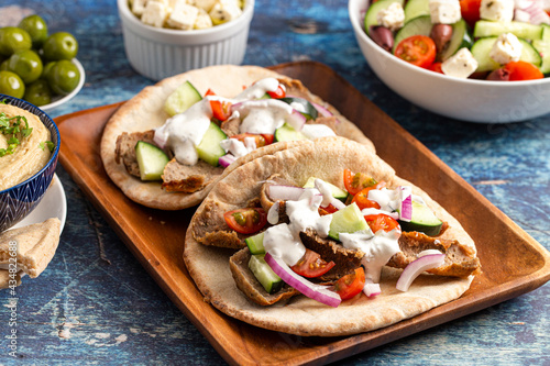 Gyros with Vegetables and White Garlic Sauce on a Rustic Wooden Table