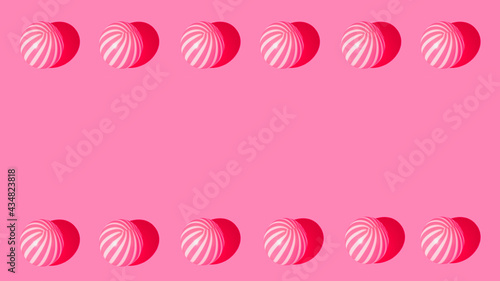 Colorful summer frame made of beach ball on pastel pink background. Minimal summer concept. Flat lay. Copy space.