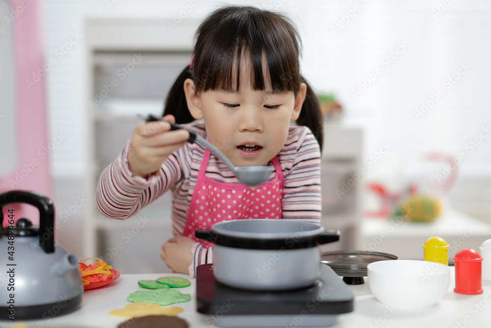 young girl pretend play food preparing at home young girl pretend play food preparing at home