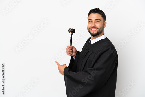 Judge arab man isolated on white background pointing back