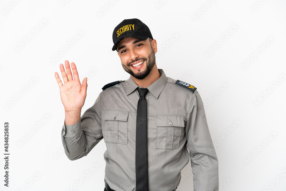 Young arab man isolated on white background saluting with hand with happy expression Young arab man isolated on white background saluting with hand with happy expression