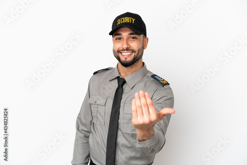 Young arab man isolated on white background inviting to come with hand. Happy that you came photo