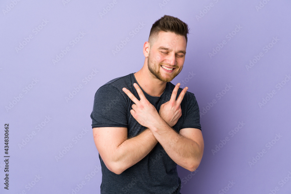 Russian handsome man over isolated background smiling and showing victory sign Russian handsome man over isolated background smiling and showing victory sign