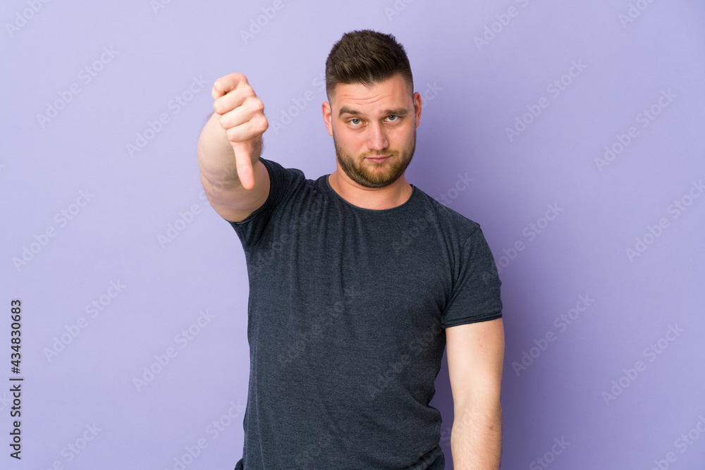 Russian handsome man over isolated background showing thumb down with negative expression Russian handsome man over isolated background showing thumb down with negative expression