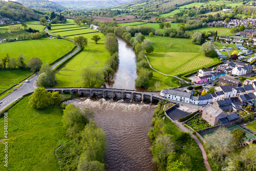 Aerial view of an old bridge across a fast flowing river photo