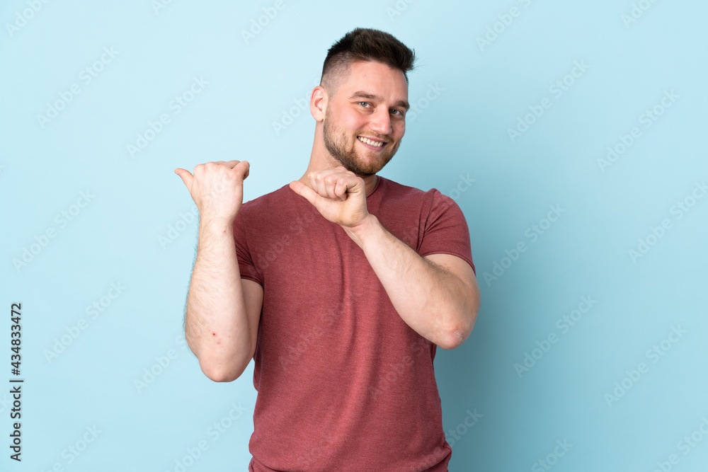 Russian handsome man over isolated background pointing to the side to present a product Russian handsome man over isolated background pointing to the side to present a product