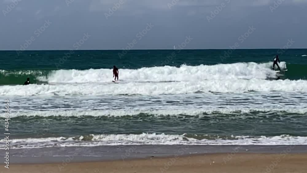 Serfers and serfing at Tel Baruch Mediterranean sea beach. Tel Aviv, Israel. HD Serfers and serfing at Tel Baruch Mediterranean sea beach. Tel Aviv, Israel. HD