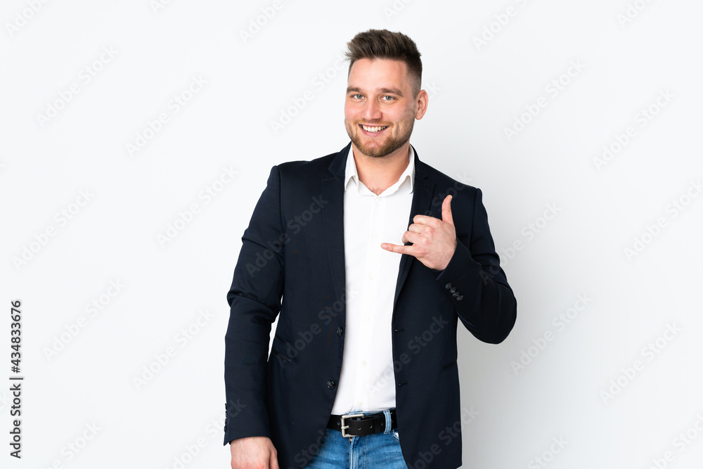 Young Russian business man isolated on white background making phone gesture Young Russian business man isolated on white background making phone gesture