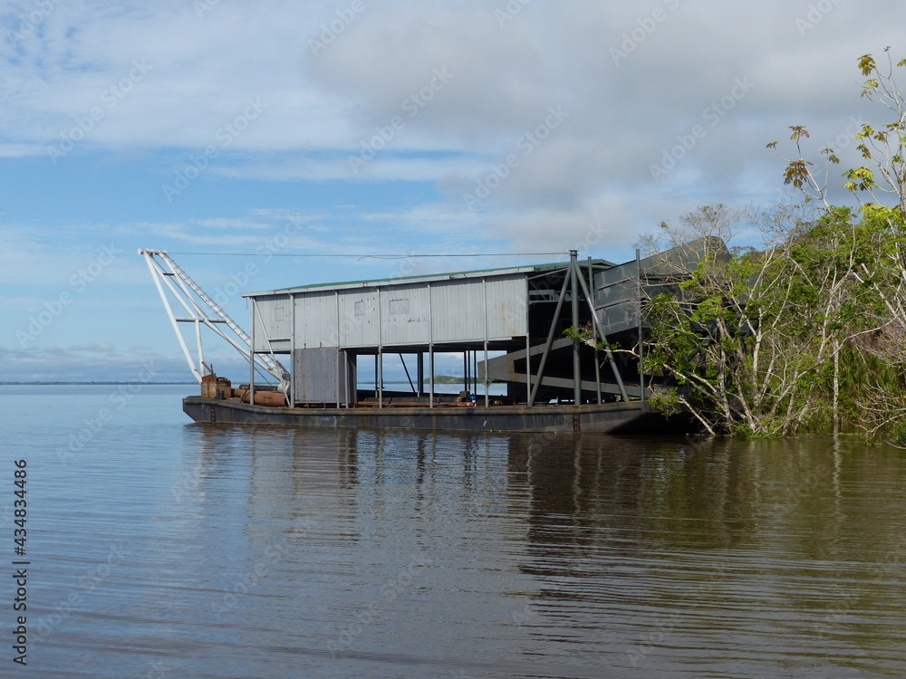 Dredging is the excavation of material from a water environment. With this system the gold miners try to mine gold. Amazon, Brazil. Dredging is the excavation of material from a water environment. With this system the gold miners try to mine gold. Amazon, Brazil.