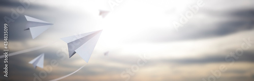 paper planes flying in a beautiful afternoon