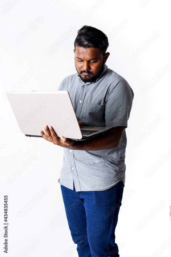 Professional man holding a laptop and thinking isolated on white background Professional man holding a laptop and thinking isolated on white background