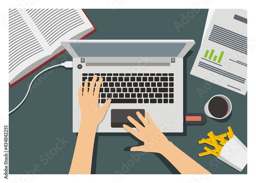 Hand typing laptop, surrounded with snacks, coffee, and other things