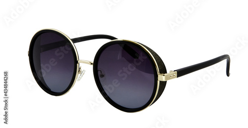 Sunglasses with black and gold round rims and black temples isolated on white background