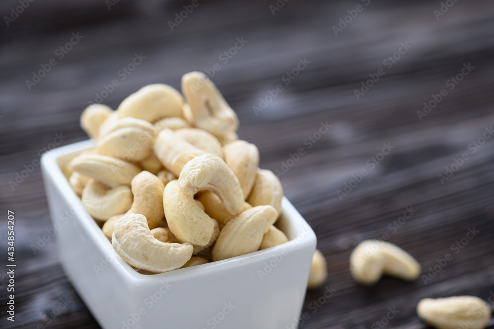 Full Raw Cashew Nuts in white ceramic bowl