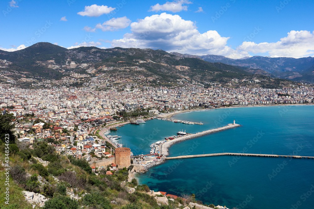 panoramic view to the city of Alanya, marina, sea and mountains from the top of the fortress wall
