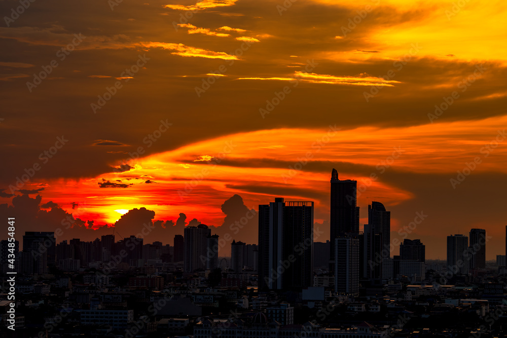 Fototapeta premium The blurred abstract background of the morning sun exposure to the tiny dust particles that surround the tall buildings in the capital, the long-term health issue of pollution