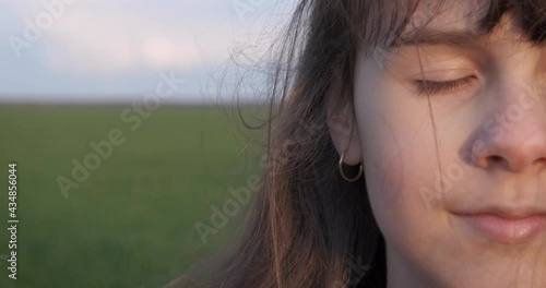 Teen relax in summer wind. A happy smiling teen stay in the summer wind in the field in the day light.