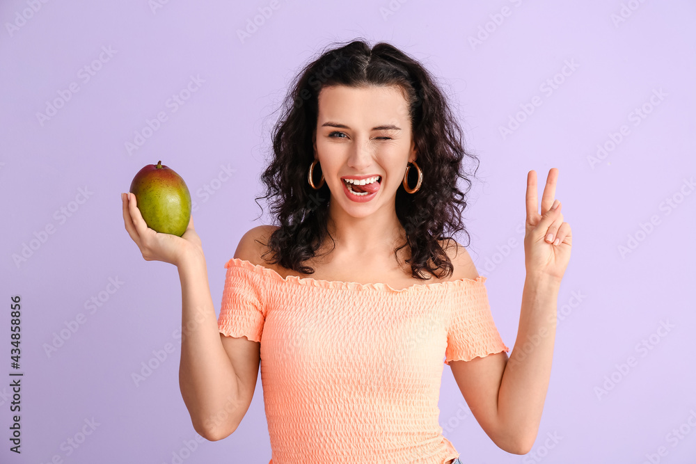 Beautiful woman with fresh mango on color background Beautiful woman with fresh mango on color background