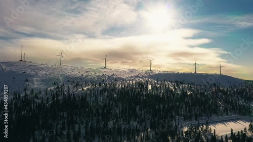 Aerial view of windmills on top of the Olostunturi mountain, sunny evening in Olos, Lapland - tracking, drone shot photo