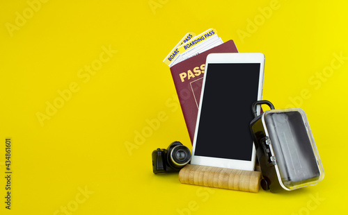 Passports, plane tickets, smartfone and suitcase ready for vacation. Travelling concept photo