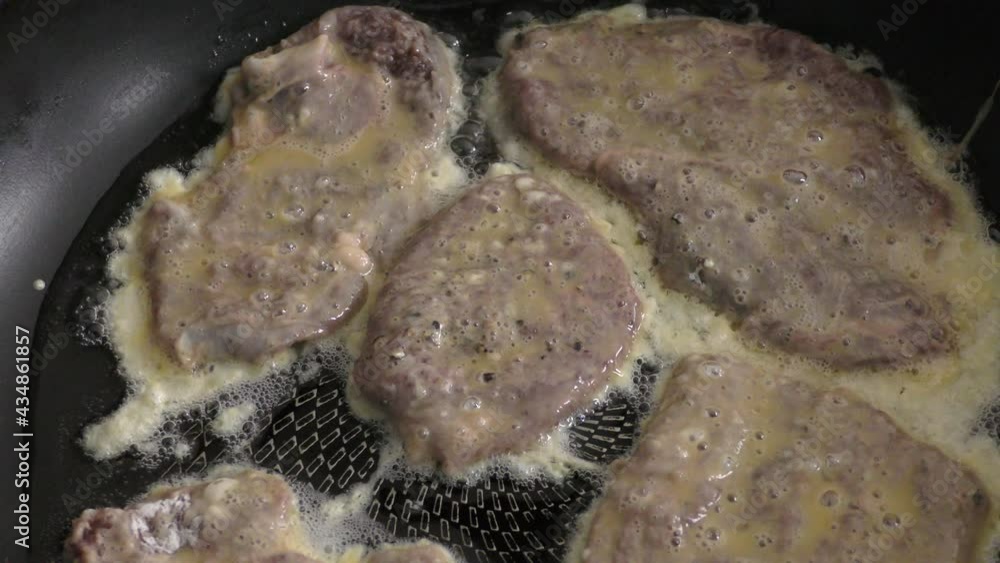 deer steaks are being fried in a pan. healthy food concept deer steaks are being fried in a pan. healthy food concept