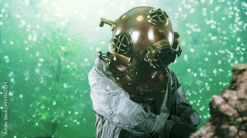 A deep sea diver working on the sea bed floor. The vintage navy diver's helmet is copper and brass providing air for breathing under water in the ocean