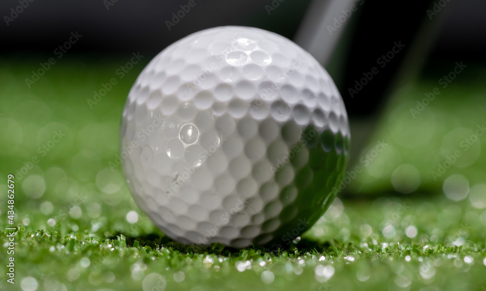 Close up of a used golf ball on a dark background Close up of a used golf ball on a dark background