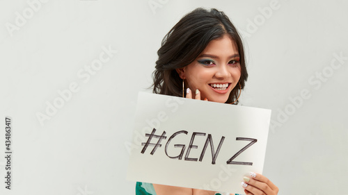 Pretty young excited woman holding #GENZ text in board photo