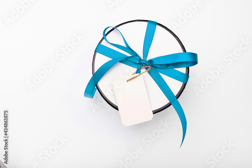 Gift box on a white background. mock-up. gift round white box with a blue bow on a light background in a row. surprise for christmas and new year. birthday present macro top view