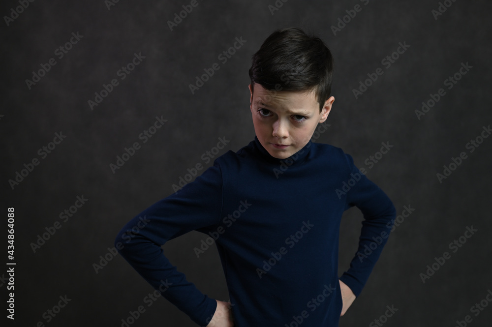 Portrait of a teenager caucasian guy serious on a gray background Portrait of a teenager caucasian guy serious on a gray background