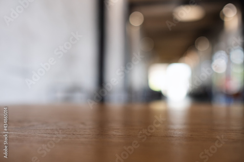 Wooden table top with blurred background in cafe