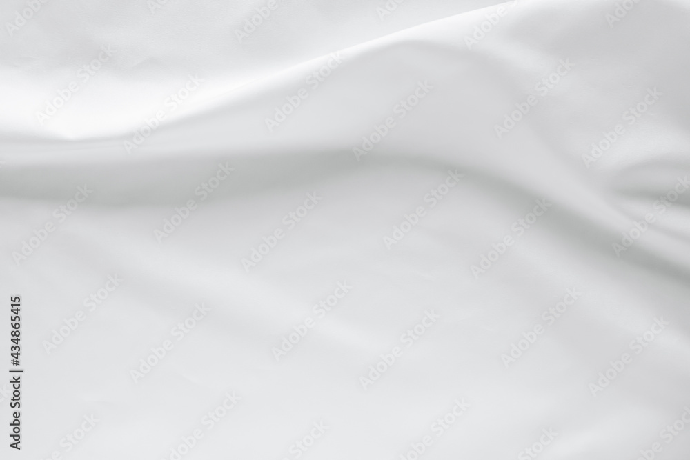 Abstract white fabric texture background. Cloth soft wave. Creases of satin, silk, and cotton.	